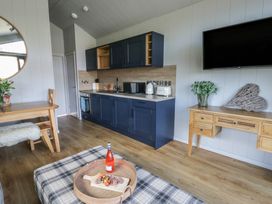 A kitchen with a table and stools at Fawn’s Rest Nantmel near Rhayader