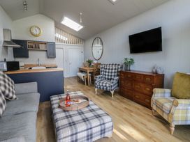 A living room with a sofa and television at Doe Lodge Nantmel near Rhayader