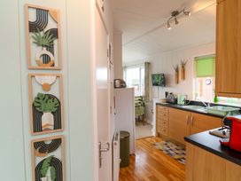 A kitchen with a refrigerator and cabinets at Daffodil Lodge Mullacott near Ilfracombe