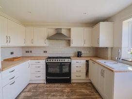 A kitchen with a cooker and sink at 10 The Gardens Rousdon near Lyme Regis