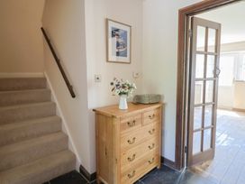 A hallway with staircase and chest of drawers at 10 The Gardens Rousdon near Lyme Regis