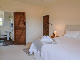 A bedroom with a bed and nightstand at 10 The Gardens, Rousdon near Lyme Regis