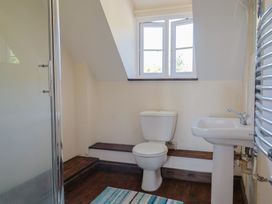 A bathroom with a shower, toilet, and sink at 10 The Gardens in Rousdon near Lyme Regis