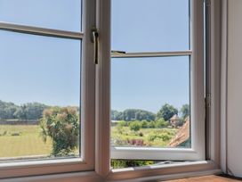 A window view of a landscape at 10 The Gardens in Rousdon near Lyme Regis