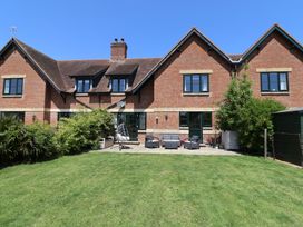 A garden with a house and patio furniture at 10 The Gardens Rousdon near Lyme Regis