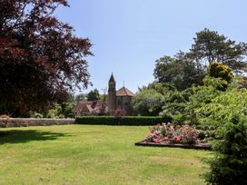 A garden with flowers and trees at 10 The Gardens, Rousdon near Lyme Regis