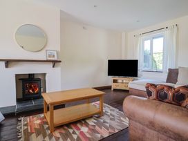 A living room with a coffee table and a fireplace at 10 The Gardens Rousdon near Lyme Regis