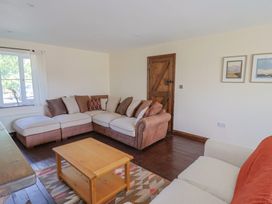 A living room with a sofa and coffee table at 10 The Gardens Rousdon near Lyme Regis