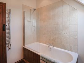 A bathroom featuring a bathtub and shower at 10 The Gardens Rousdon near Lyme Regis