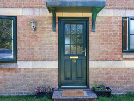 A front door with number 10 and a light fixture at 10 The Gardens Rousdon near Lyme Regis