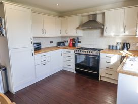 A kitchen with cabinets, oven, and countertop at 10 The Gardens Rousdon near Lyme Regis
