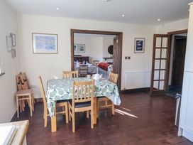 A dining room with a table and chairs at 10 The Gardens in Rousdon near Lyme Regis