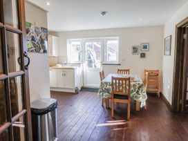 A dining room with a table and chairs in 10 The Gardens Rousdon near Lyme Regis