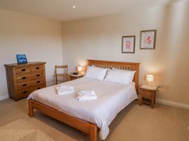 A bedroom with a bed and a dresser at 10 The Gardens Rousdon near Lyme Regis