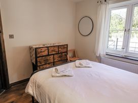 A bedroom with a bed and a dresser at 10 The Gardens Rousdon near Lyme Regis
