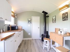 A kitchen with a sink and stove at Cuckoo at Wild Valley Huts Llanrhaeadr-Ym-Mochnant