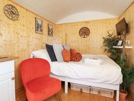 A bedroom with a bed and decor at Red Kite at Wild Valley Huts Llanrhaeadr-Ym-Mochnant