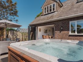 A hot tub with patio furniture at Tokenhill Cottage Piddletrenthide