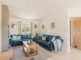 A living room with sofas and a coffee table at Tokenhill Cottage in Piddletrenthide