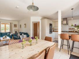 A dining room with a table and chairs at Tokenhill Cottage Piddletrenthide