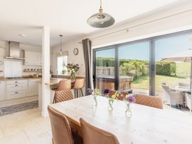 A kitchen with a table and chairs at Tokenhill Cottage Piddletrenthide