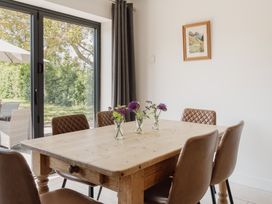 A dining room with a wooden table and chairs at Tokenhill Cottage Piddletrenthide