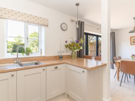 A kitchen with a sink and countertop at Tokenhill Cottage in Piddletrenthide