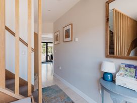 A hallway with a table and stairs at Tokenhill Cottage in Piddletrenthide
