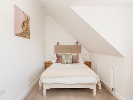 A bedroom with a bed and bedside table at Tokenhill Cottage in Piddletrenthide