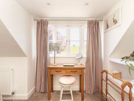 An office with a wooden desk and lamp at Tokenhill Cottage in Piddletrenthide