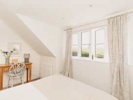 A bedroom with a desk and chair at Tokenhill Cottage in Piddletrenthide