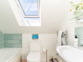 A bathroom with a toilet and bath tub at Tokenhill Cottage in Piddletrenthide