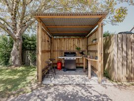 An outdoor kitchen with a grill and counter at Tokenhill Cottage in Piddletrenthide