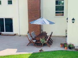 An outdoor seating area with a table and chairs at Brooklands in Uplyme