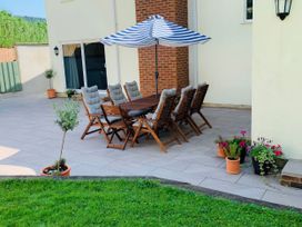 An outdoor dining area with table and chairs at Brooklands in Uplyme