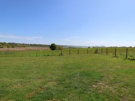 A field with a fence and tree at Polly's Annexe Levington