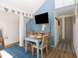 A dining room with a table and chairs at Borth Arian Boat House Holyhead