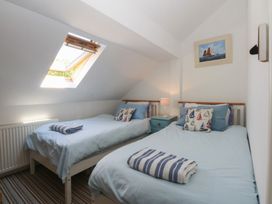 A bedroom with two beds and a window at Borth Arian Boat House Holyhead