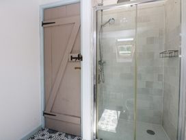 A bathroom with a shower and sliding door at Borth Arian Boat House in Holyhead