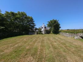 A house with a garden and trees at Borth Arian Boat House in Holyhead