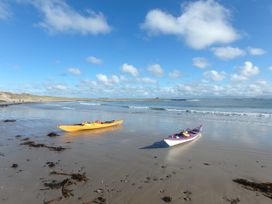 Two kayaks on the beach at Borth Arian Boat House Rhoscolyn