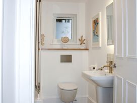 A bathroom with a toilet and sink at 2 Channel View Salcombe