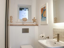 A bathroom with a sink and a toilet at 2 Channel View in Salcombe