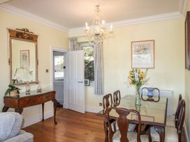 A dining room with a table and chairs at 2 Channel View in Salcombe