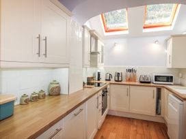 A kitchen with cabinets and appliances at 2 Channel View Salcombe