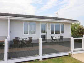 An outdoor area with a deck and seating at Bonny Bay in Wilsthorpe near Bridlington