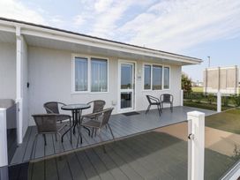 An outdoor patio with a table and chairs at Bonny Bay in Wilsthorpe near Bridlington