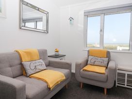 A living room with a sofa and armchair at Bonny Bay in Wilsthorpe near Bridlington