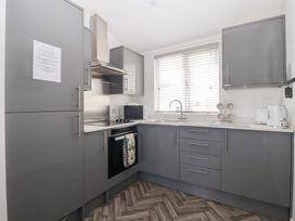 A kitchen with gray cabinets and appliances at Bonny Bay Wilsthorpe near Bridlington