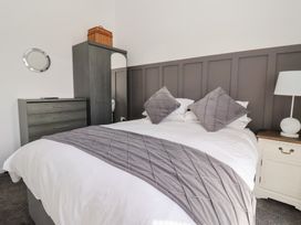 A bedroom with a bed and wardrobe at Bonny Bay in Wilsthorpe near Bridlington